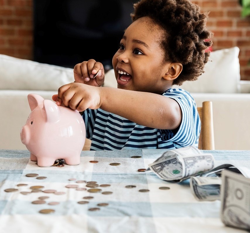 toddler with piggy bank